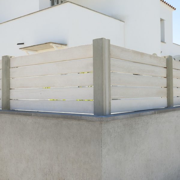 Valla imitación madera con vivienda al fondo